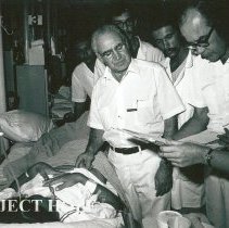Dr Robert Wochos, Surgeon, Rotation I, checking patient with counterpart.